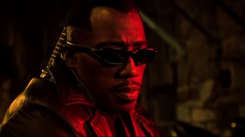Movie still from “Blade II” (2002), directed by Guillermo del Toro – A person wearing sunglasses; Close Up shot, Low angle