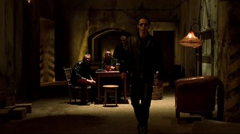 Movie still from “Blade II” (2002), directed by Guillermo del Toro – A group of people sitting in a living room; Wide shot, Low angle