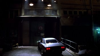 Movie still from “Blade II” (2002), directed by Guillermo del Toro – A car is parked in a garage at night; Wide shot, Low angle