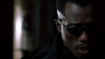 Movie still from “Blade II” (2002), directed by Guillermo del Toro – A person wearing sunglasses; Close Up shot, Low angle