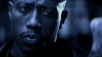 Movie still from “Blade II” (2002), directed by Guillermo del Toro – A man's face in blue light; Close Up shot, Low angle