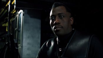 Movie still from “Blade II” (2002), directed by Guillermo del Toro – A man wearing a black shirt and a black jacket; Close Up shot, Over the shoulder angle