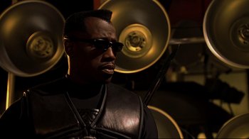 Movie still from “Blade II” (2002), directed by Guillermo del Toro – A man in a leather jacket and sunglasses; Close Up shot, Low angle