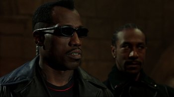 Movie still from “Blade II” (2002), directed by Guillermo del Toro – A man with sunglasses and a leather jacket; Close Up shot, Low angle