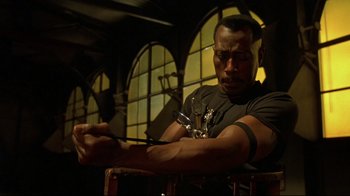 Movie still from “Blade II” (2002), directed by Guillermo del Toro – A man holding a pair of scissors in his hand; Medium shot, Low angle