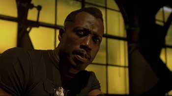 Movie still from “Blade II” (2002), directed by Guillermo del Toro – A person wearing a black t - shirt; Close Up shot, Low angle