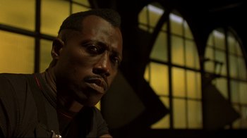 Movie still from “Blade II” (2002), directed by Guillermo del Toro – A person wearing a black t - shirt; Close Up shot, Low angle
