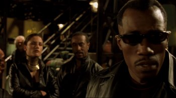 Movie still from “Blade II” (2002), directed by Guillermo del Toro – A group of men standing next to each other in a room; Close Up shot, Low angle