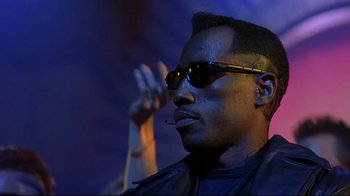 Movie still from “Blade II” (2002), directed by Guillermo del Toro – A person wearing sunglasses; Close Up shot, Low angle