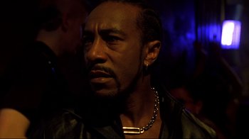 Movie still from “Blade II” (2002), directed by Guillermo del Toro – A person wearing a necklace; Close Up shot, Low angle