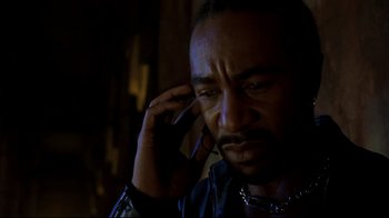 Movie still from “Blade II” (2002), directed by Guillermo del Toro – A person talking on a cell phone; Close Up shot, High angle