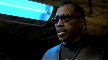 Movie still from “Blade II” (2002), directed by Guillermo del Toro – A person wearing sunglasses and a leather jacket; Close Up shot, Low angle