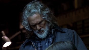 Movie still from “Blade II” (2002), directed by Guillermo del Toro – An older man with long gray hair and a beard; Close Up shot, Over the shoulder angle