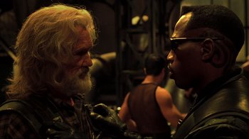 Movie still from “Blade II” (2002), directed by Guillermo del Toro – A man with long white hair and a beard talking to a man with short black hair; Close Up shot, Over the shoulder angle