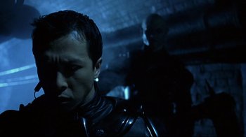 Movie still from “Blade II” (2002), directed by Guillermo del Toro – A man in a black leather jacket standing next to another man in a black leather jacket; Close Up shot, Over the shoulder angle