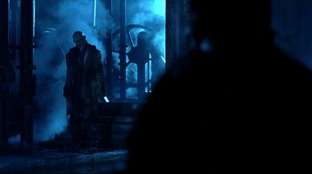 Movie still from “Blade II” (2002), directed by Guillermo del Toro – A man standing on steps in front of a building; Wide shot, Low angle