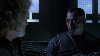 Movie still from “Blade II” (2002), directed by Guillermo del Toro – A man and a woman are talking in a room; Close Up shot, Over the shoulder angle