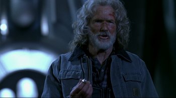 Movie still from “Blade II” (2002), directed by Guillermo del Toro – An older man with a long white beard holding a cigarette in his mouth; Close Up shot, Over the shoulder angle