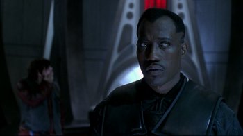 Movie still from “Blade II” (2002), directed by Guillermo del Toro – A person wearing a suit and tie; Close Up shot, Over the shoulder angle