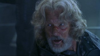 Movie still from “Blade II” (2002), directed by Guillermo del Toro – An older man with a scar on his face; Close Up shot, Over the shoulder angle