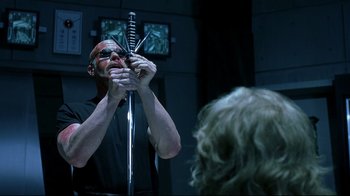 Movie still from “Blade II” (2002), directed by Guillermo del Toro – A man holding a sword in front of a mirror; Close Up shot, Over the shoulder angle