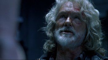 Movie still from “Blade II” (2002), directed by Guillermo del Toro – An older man with white hair and a beard; Close Up shot, Low angle