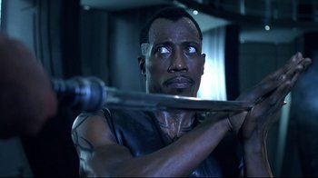 Movie still from “Blade II” (2002), directed by Guillermo del Toro – A person holding a baseball bat; Close Up shot, Low angle