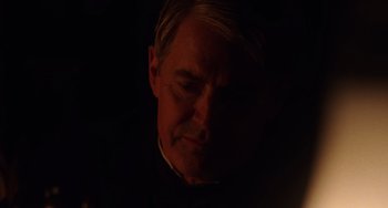 Movie still from “Tesla” (2020), directed by Michael Almereyda – A person in a dark room; Close Up shot, Over the shoulder angle