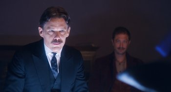 Movie still from “Tesla” (2020), directed by Michael Almereyda – A man in a suit and tie next to another man in a suit and tie; Medium shot, Over the shoulder angle