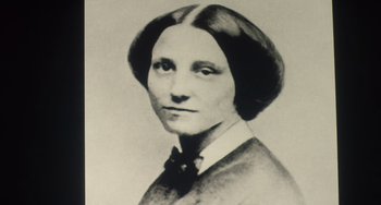 Movie still from “Tesla” (2020), directed by Michael Almereyda – An old black and white photo of a woman; Close Up shot, Low angle