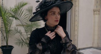 Movie still from “Tesla” (2020), directed by Michael Almereyda – A woman in a black dress and a black hat; Close Up shot, Low angle