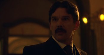 Movie still from “Tesla” (2020), directed by Michael Almereyda – A person wearing a suit and tie; Close Up shot, Low angle
