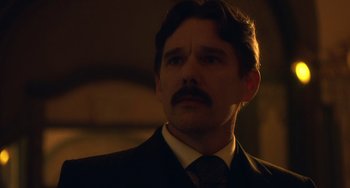 Movie still from “Tesla” (2020), directed by Michael Almereyda – A person wearing a suit and tie; Close Up shot, Low angle