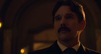 Movie still from “Tesla” (2020), directed by Michael Almereyda – A person wearing a suit and tie; Close Up shot, Low angle