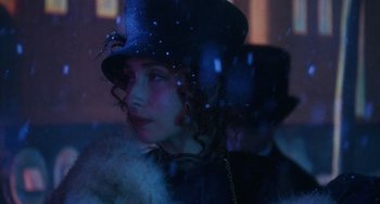 Movie still from “Tesla” (2020), directed by Michael Almereyda – A woman wearing a black hat and a fur coat; Close Up shot, Over the shoulder angle