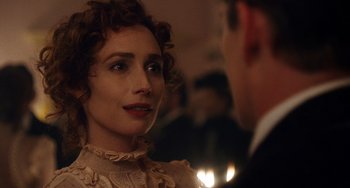 Movie still from “Tesla” (2020), directed by Michael Almereyda – A person wearing a suit and tie; Close Up shot, Over the shoulder angle