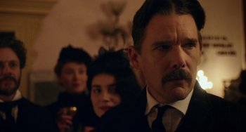 Movie still from “Tesla” (2020), directed by Michael Almereyda – A group of people standing next to each other in a room; Close Up shot, Low angle
