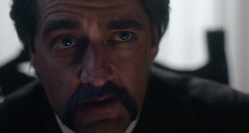Movie still from “Tesla” (2020), directed by Michael Almereyda – A person with a mustache; Close Up shot, Over the shoulder angle