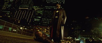Movie still from “Blade: Trinity” (2004), directed by David S. Goyer – A man in a trench coat is standing next to another man in a trench coat; Wide shot, Low angle