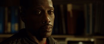 Movie still from “Blade: Trinity” (2004), directed by David S. Goyer – A man's face in a dark room; Close Up shot, Low angle