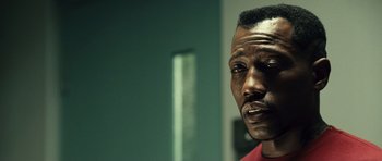 Movie still from “Blade: Trinity” (2004), directed by David S. Goyer – A man's face in front of a green wall; Close Up shot, Low angle