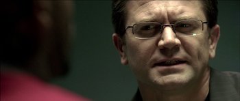 Movie still from “Blade: Trinity” (2004), directed by David S. Goyer – A person wearing glasses; Close Up shot, Over the shoulder angle