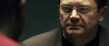 Movie still from “Blade: Trinity” (2004), directed by David S. Goyer – A person wearing a suit and glasses; Close Up shot, Over the shoulder angle
