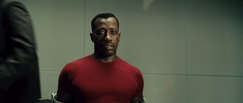 Movie still from “Blade: Trinity” (2004), directed by David S. Goyer – A man in a red t - shirt standing in front of a wall; Close Up shot, Low angle