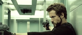 Movie still from “Blade: Trinity” (2004), directed by David S. Goyer – A person holding a gun; Close Up shot, Over the shoulder angle