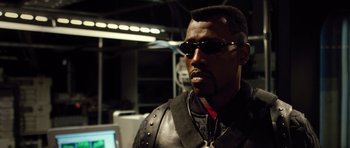 Movie still from “Blade: Trinity” (2004), directed by David S. Goyer – A man wearing a leather jacket and sunglasses; Close Up shot, Low angle
