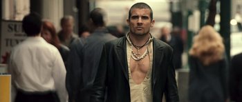 Movie still from “Blade: Trinity” (2004), directed by David S. Goyer – A man in a leather jacket with a cross necklace; Close Up shot, Low angle