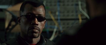 Movie still from “Blade: Trinity” (2004), directed by David S. Goyer – A person wearing sunglasses; Close Up shot, Over the shoulder angle