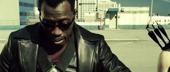 Movie still from “Blade: Trinity” (2004), directed by David S. Goyer – A man wearing a leather jacket and sunglasses; Close Up shot, Over the shoulder angle