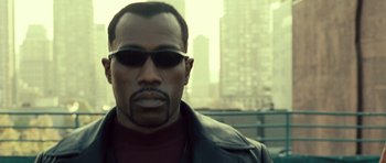Movie still from “Blade: Trinity” (2004), directed by David S. Goyer – A person wearing sunglasses and a leather jacket; Close Up shot, Low angle